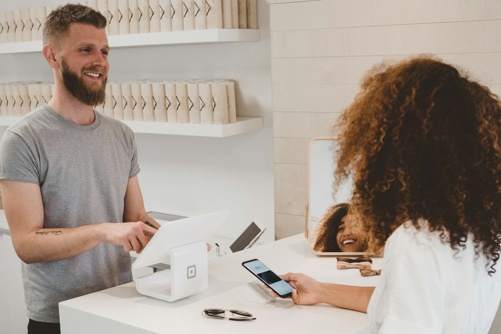 Pessoa respondendo mensagens de clientes pelo celular em um atendimento comercial