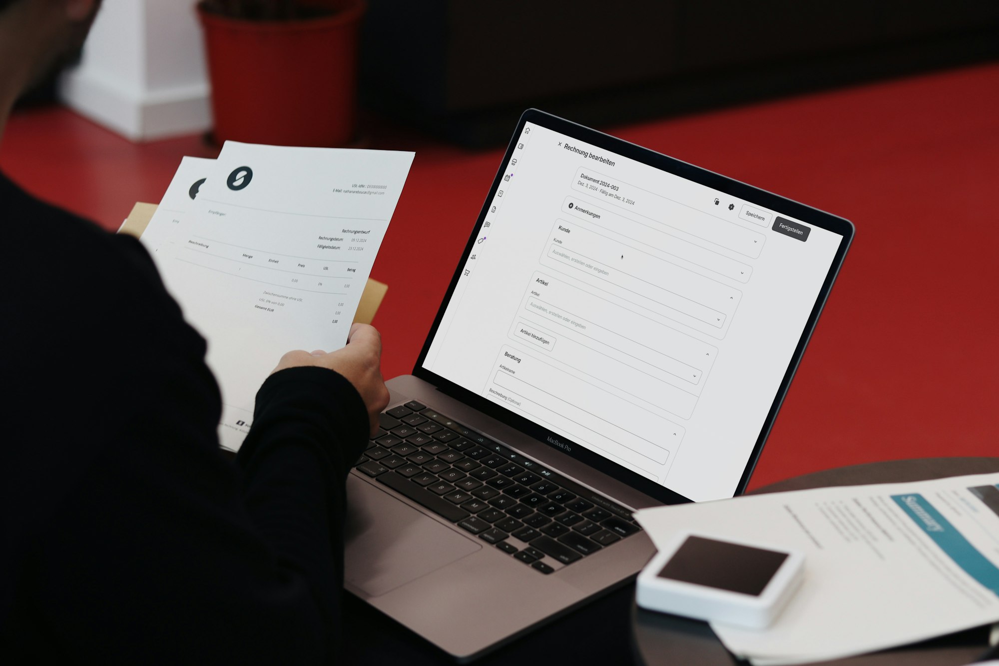 Empresário à mesa com notebook e papéis revisando faturas e assinaturas de software